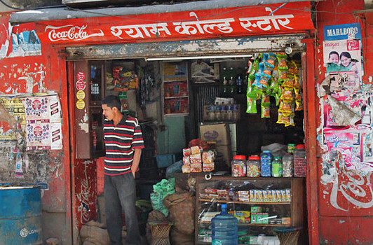 a customer standing outside a shop in nepal