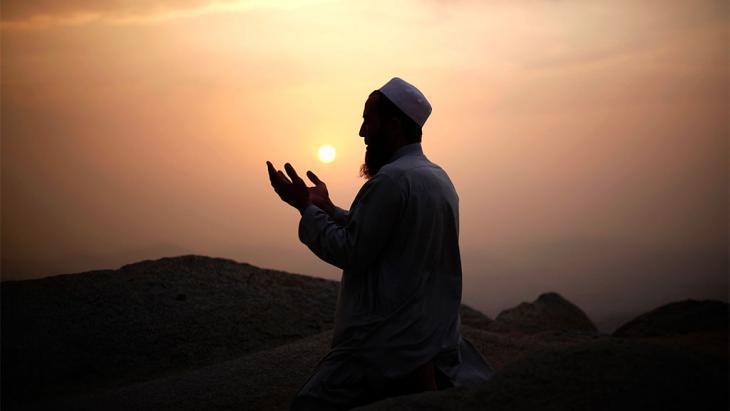 A man busy in dua to Allah at maghrib time