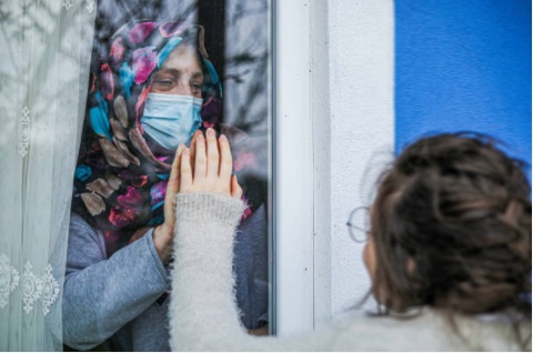 مسلمان باحجاب بزرگ خاتون ماسک پہنے قرنطینہ میں، بچی سے سلام